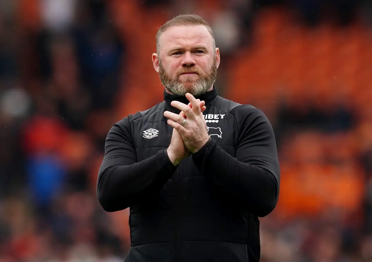 Manager Wayne Rooney applauds the Derby fans