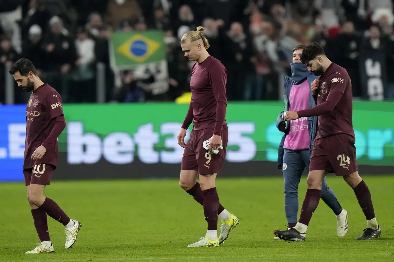 Manchester City’s Erling Haaland, center, Bernardo Silva, left, and Josko Gvardiol leave the pitch after defeat to Juventus