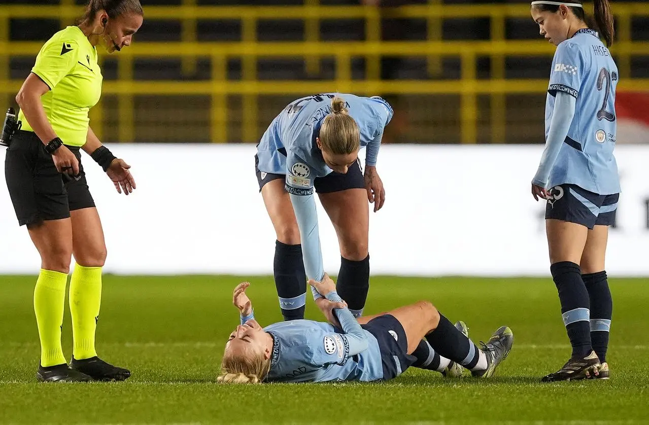 Alex Greenwood lies stricken on the pitch 