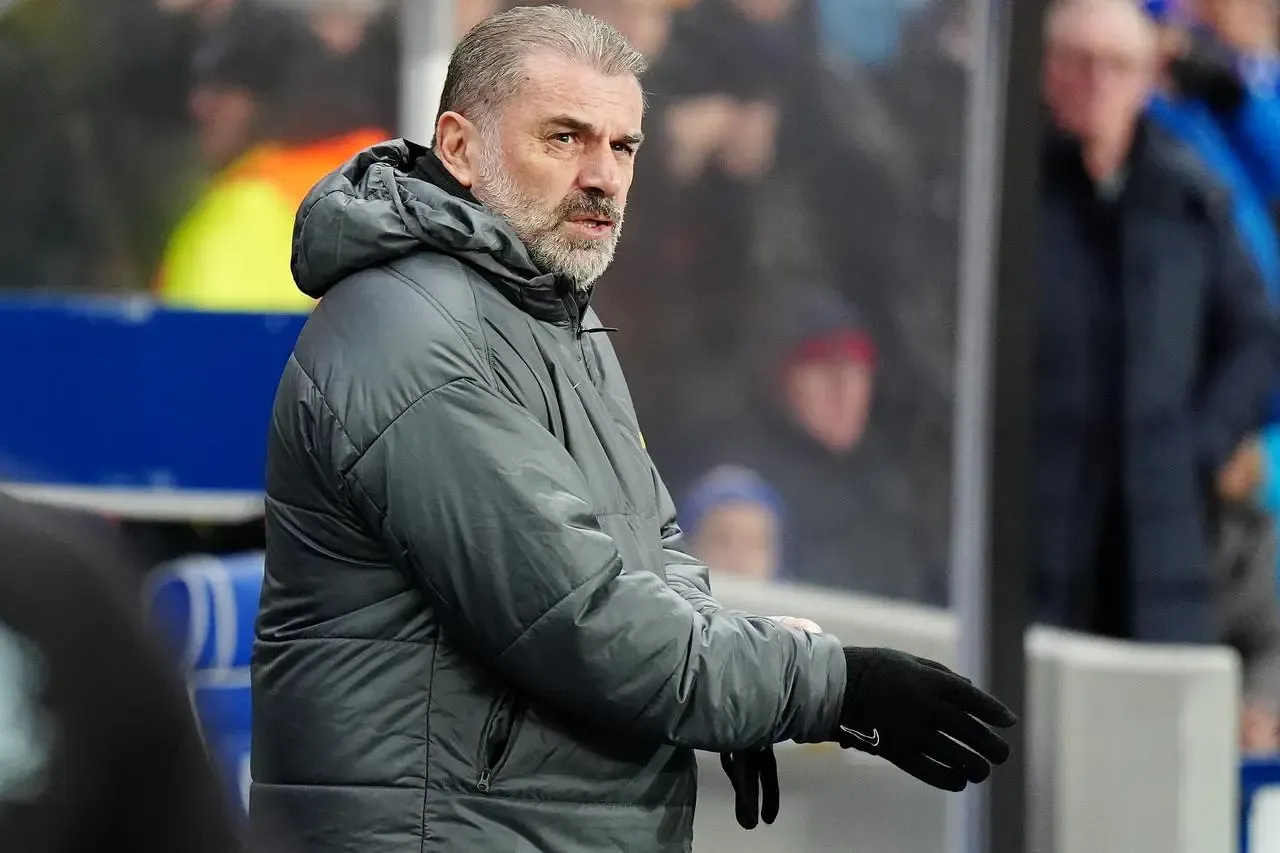 Ange Postecoglou stands in the dugout at Ibrox