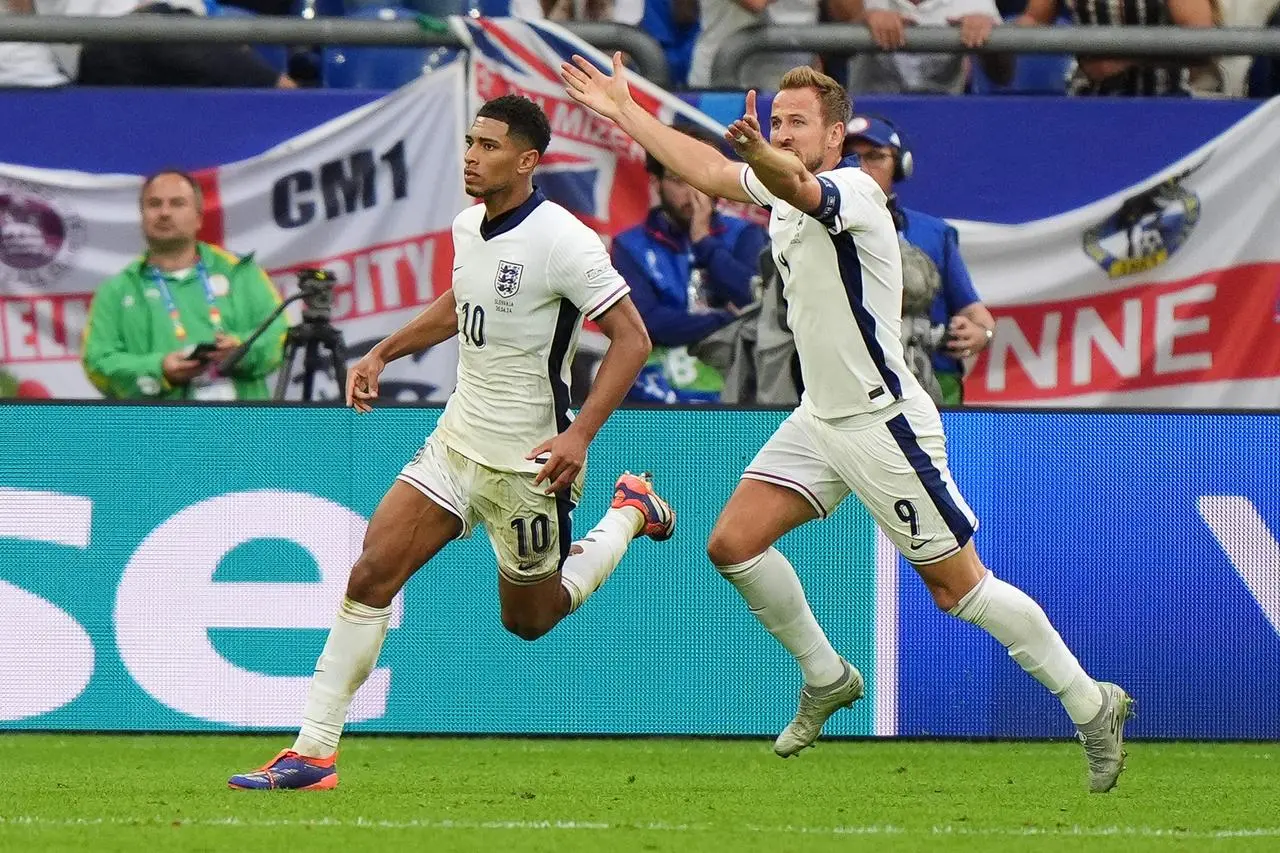 England’s Jude Bellingham celebrates with Harry Kane after scoring against Slovakia in Euro 2024