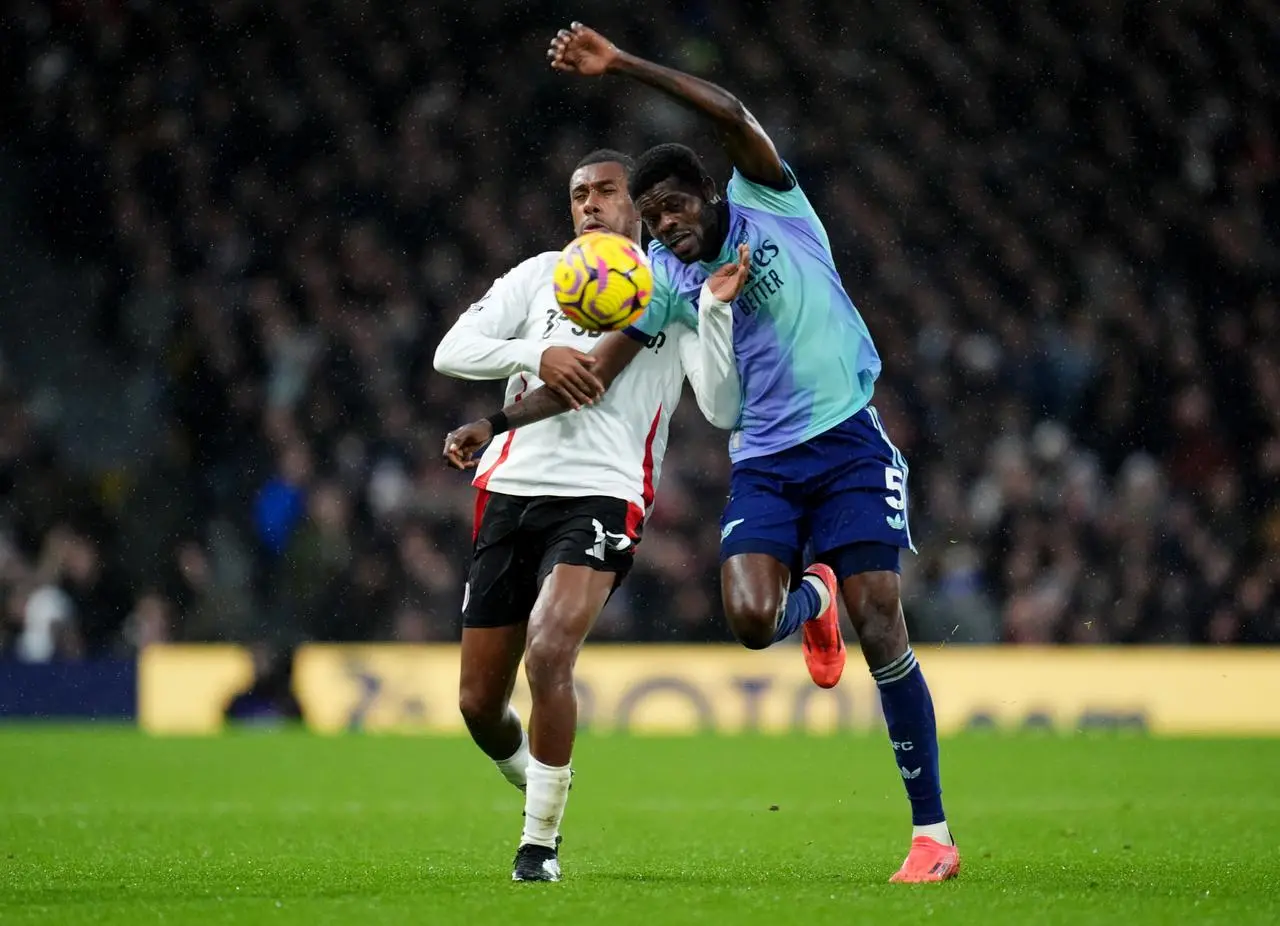 Arsenal’s Thomas Partey, right, battles for possession with Fulham’s Alex Iwobi