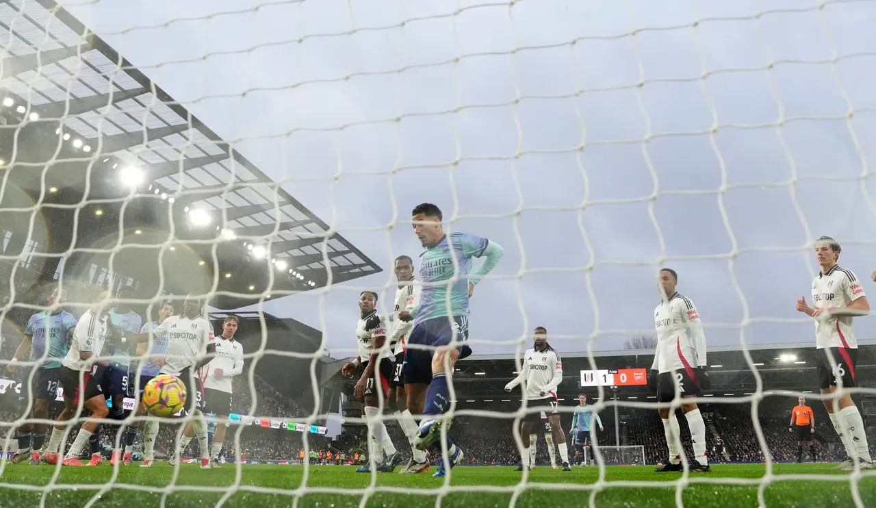 William Saliba, centre, taps in Arsenal’s equaliser against Fulham