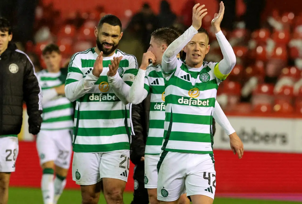 Callum McGregor applauds the fans