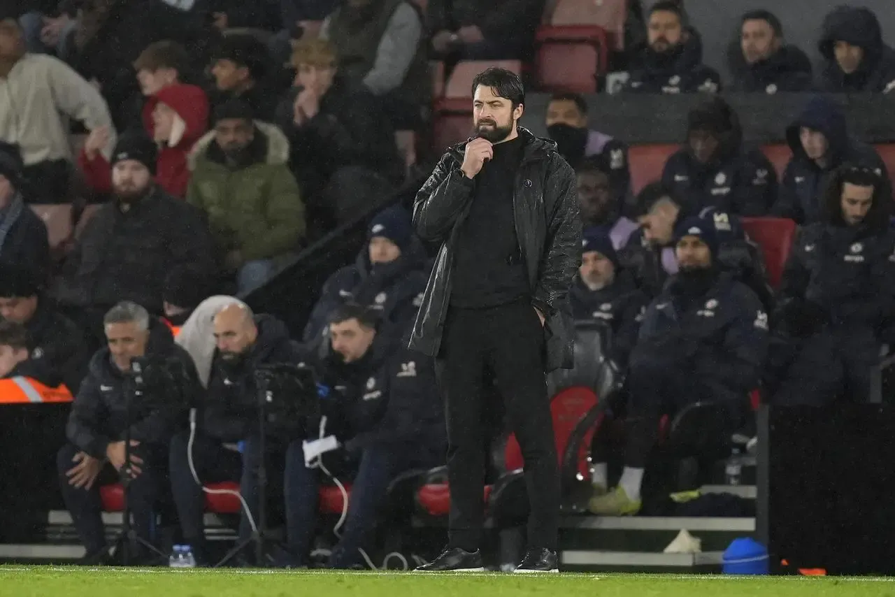 Southampton manager Russell Martin  stands in front of the dugout as he watches the game