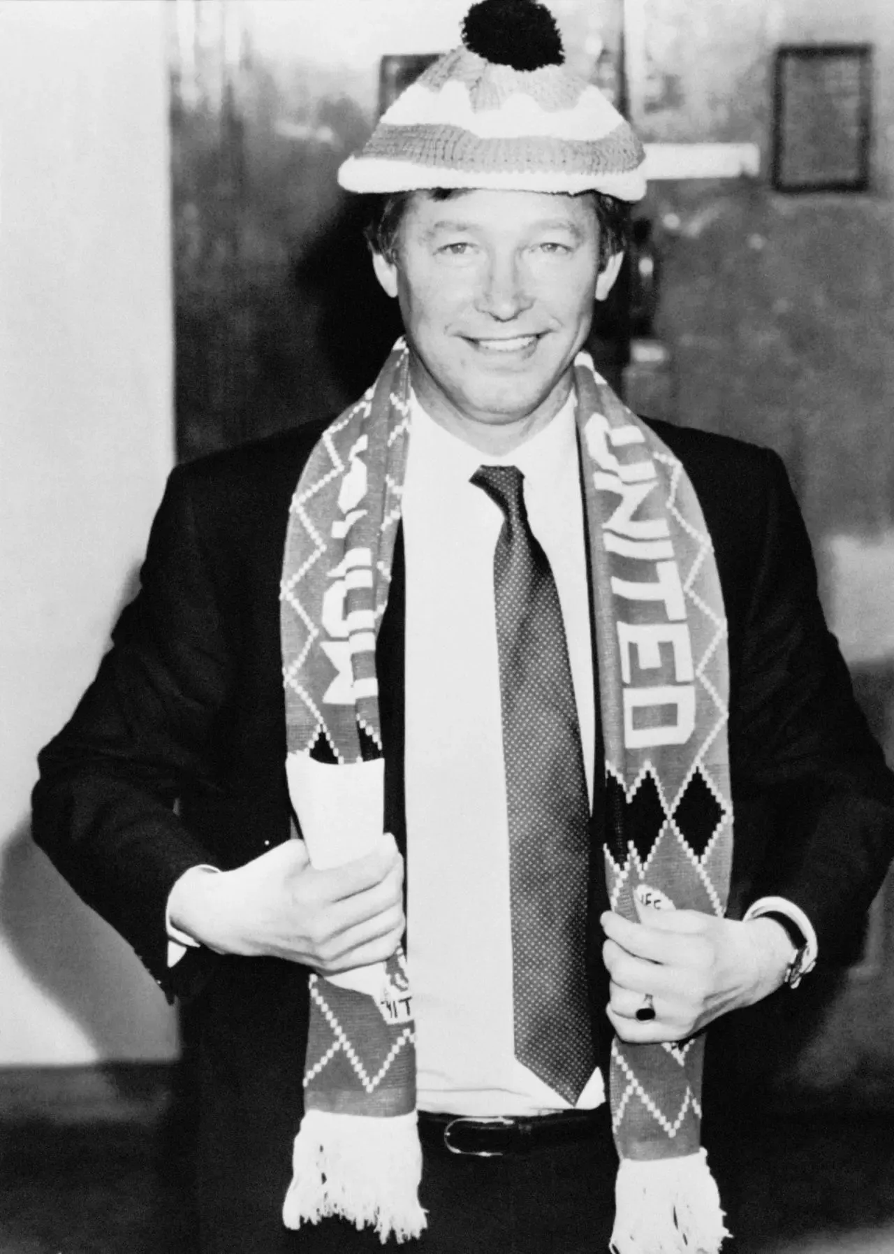 Alex Ferguson in a Manchester United scarf and bobble hat after his unveiling as their new manager in 1986