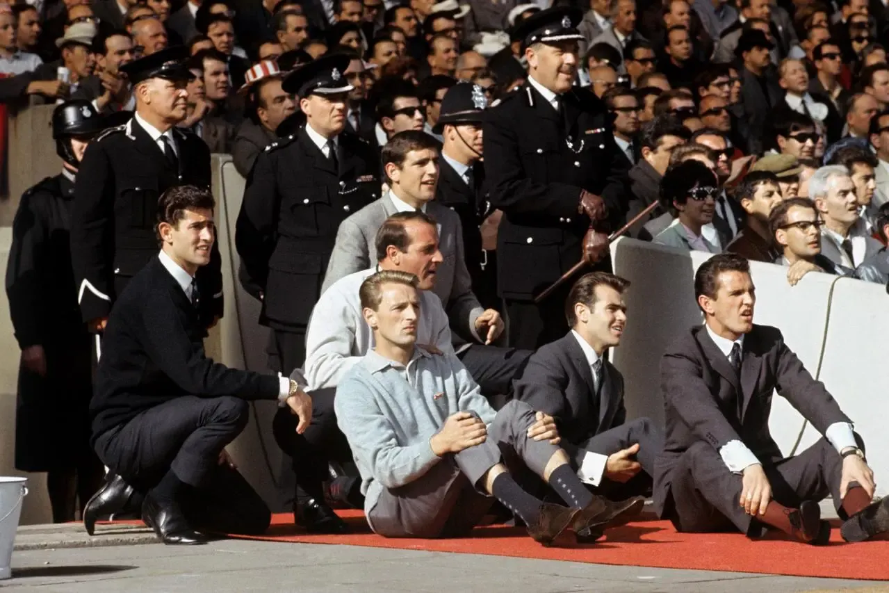 George Eastham (left, on the floor) watches England's World Cup final victory 