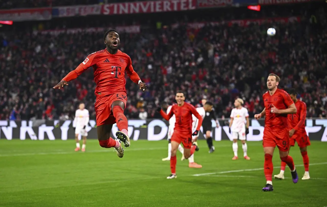 Alphonso Davies, left, celebrates scoring Bayern's fifth