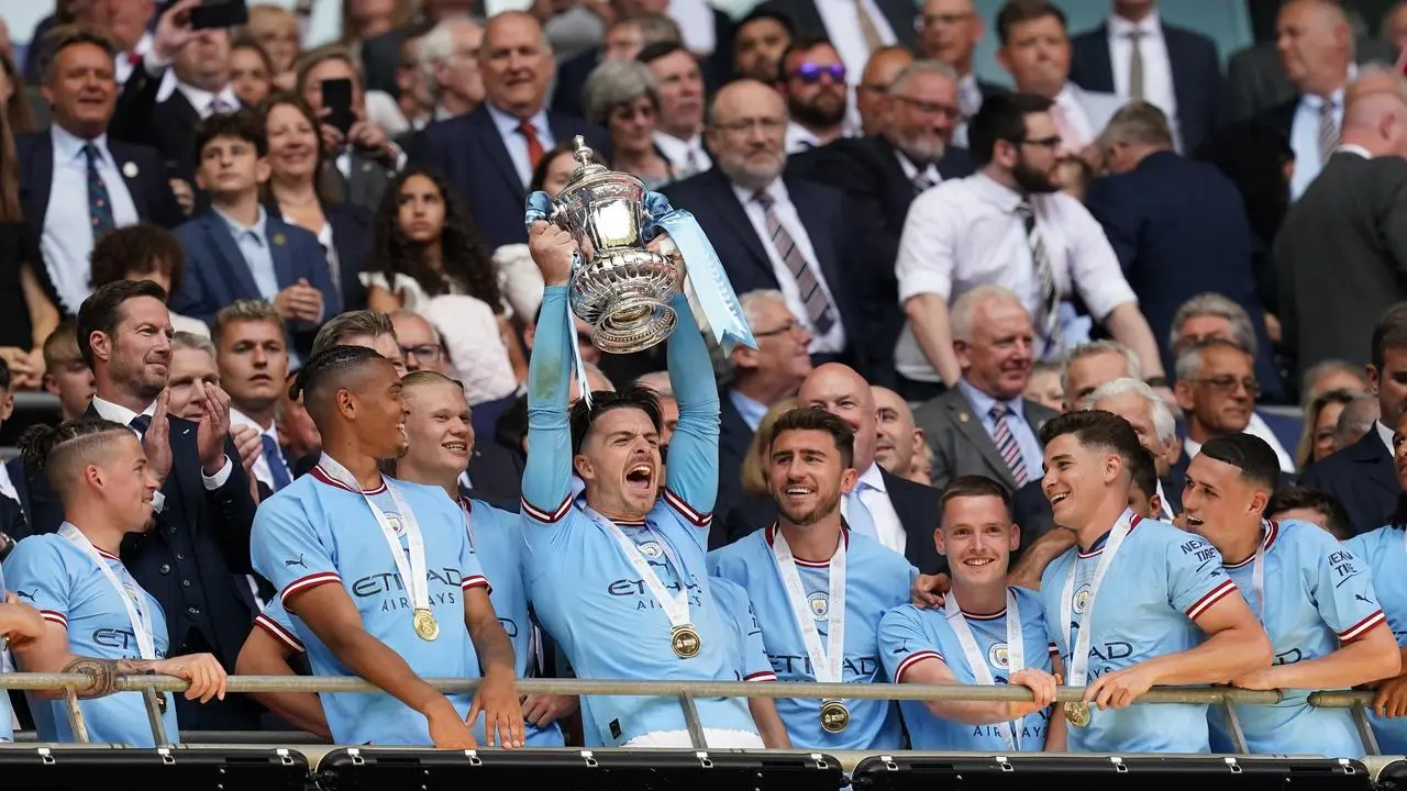 Manchester City’s Jack Grealish lifts the FA Cup trophy as he celebrates with team-mates after victory in the 2023 final