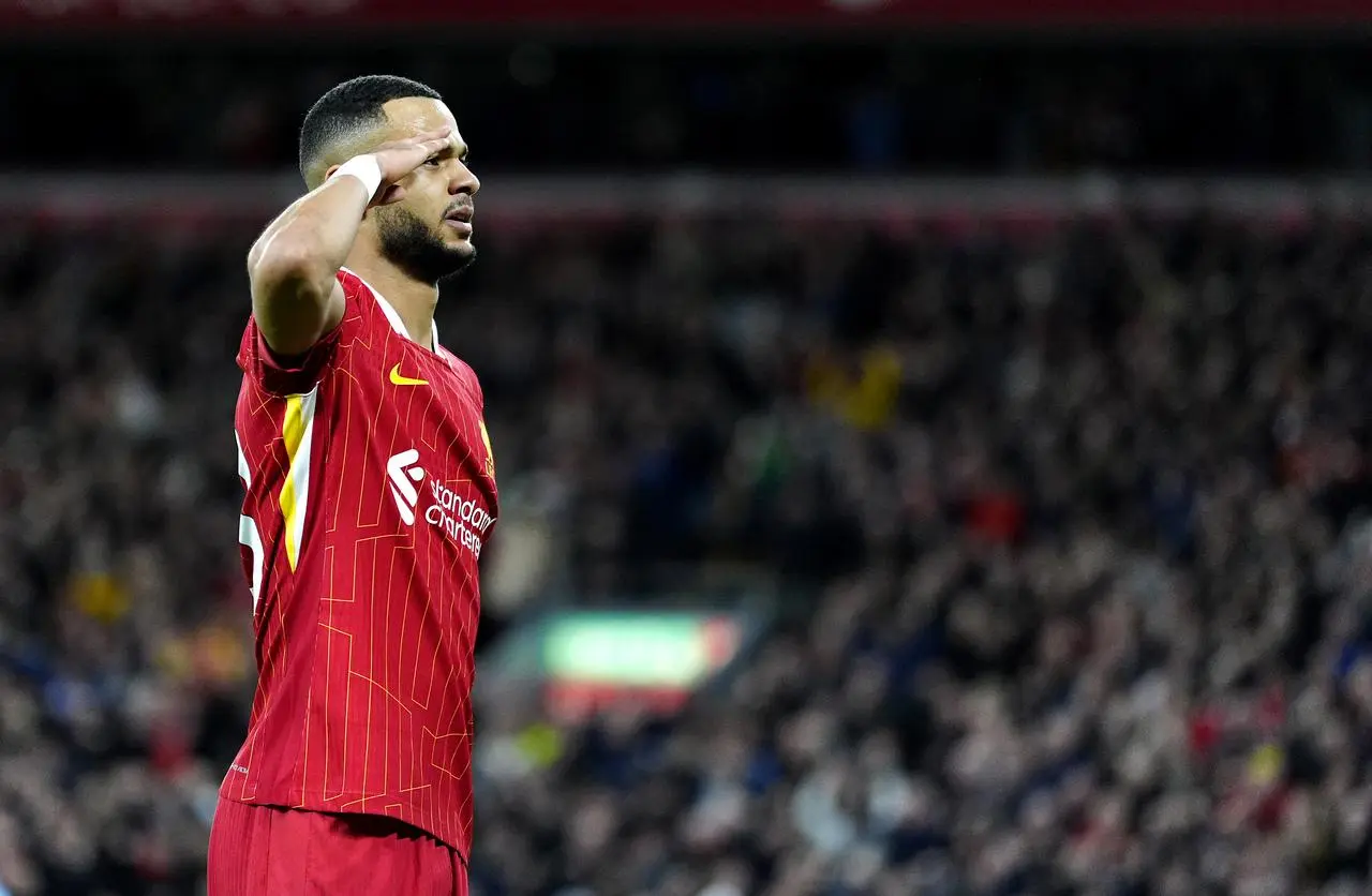 Cody Gakpo salutes the crowd at Anfield