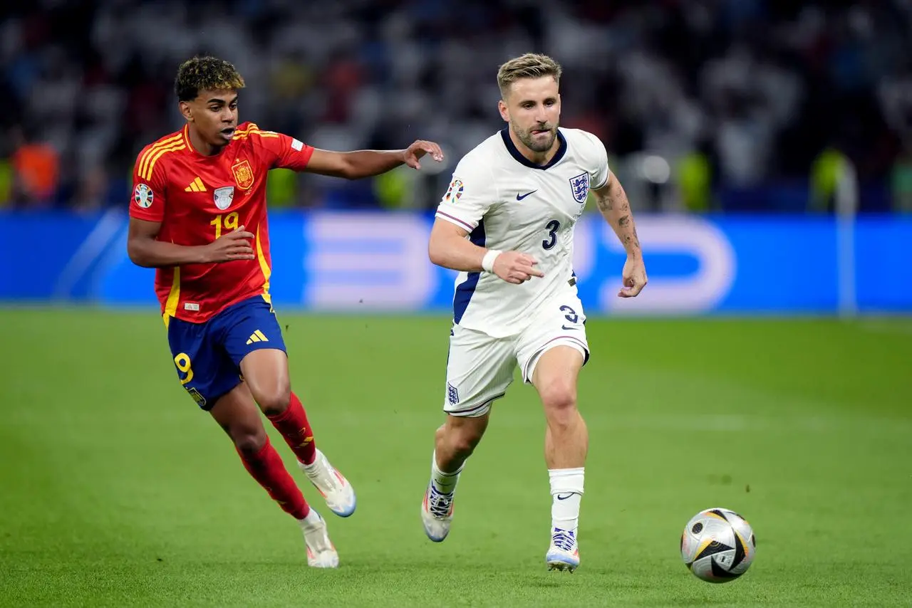 England’s Luke Shaw, right, battle for the ball with Spain's Lamine Yamal during the UEFA Euro 2024 final 