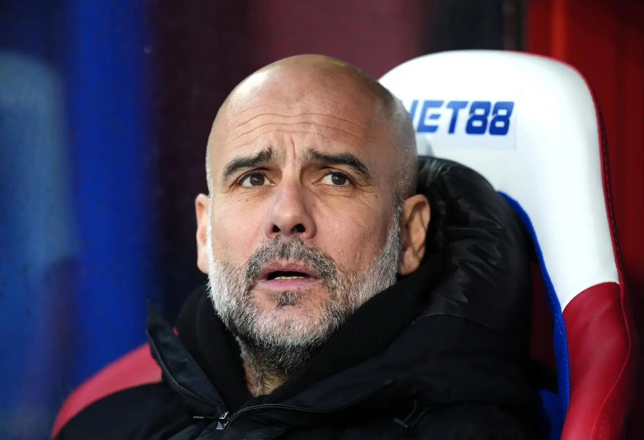 Pep Guardiola pictured in the dugout at Crystal Palace