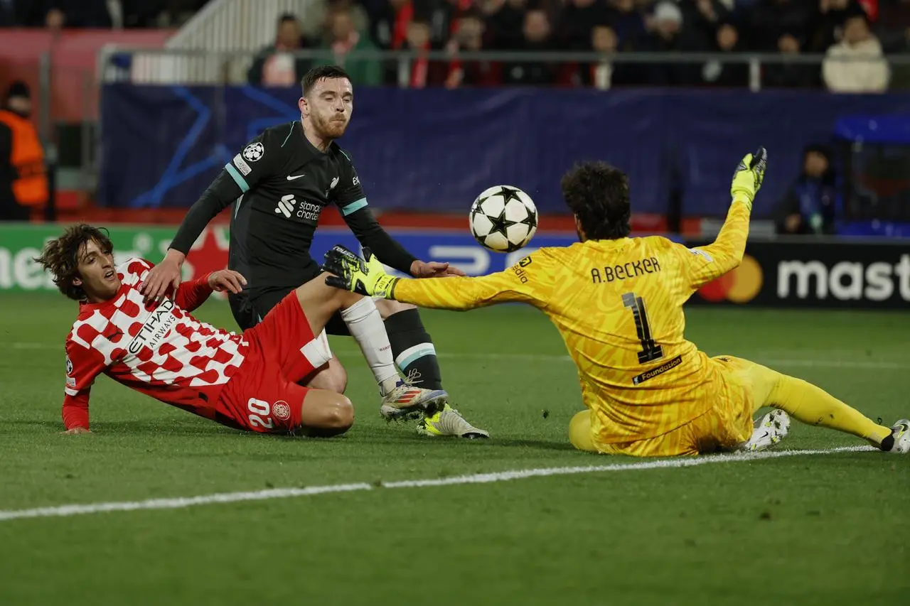 Liverpool’s goalkeeper Alisson Becker from Girona’s Bryan Gil