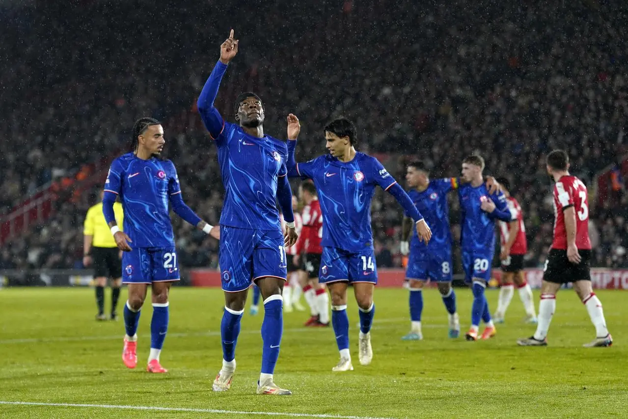 Noni Madueke celebrates scoring by pointing to the sky