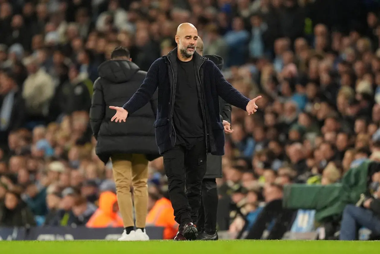 Pep Guardiola holds his arms out in frustration on the touchline