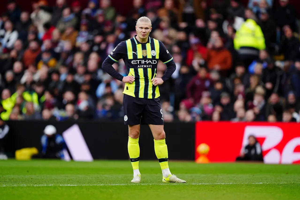 Manchester City’s Erling Haaland stands dejected with his hands on his hips at Villa Park