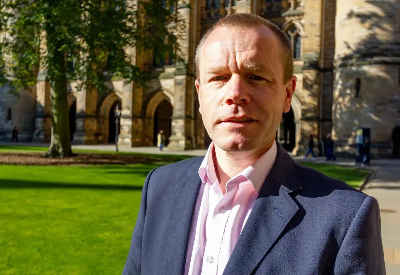 Photo of Professor Willie Stewart outside University of Glasgow buildings