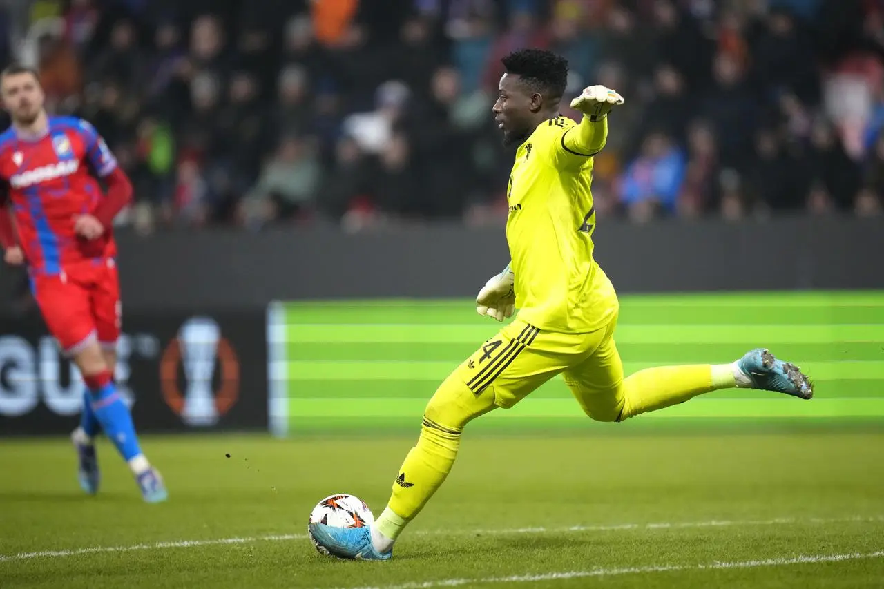 Manchester United goalkeeper Andre Onana looks to pass the ball