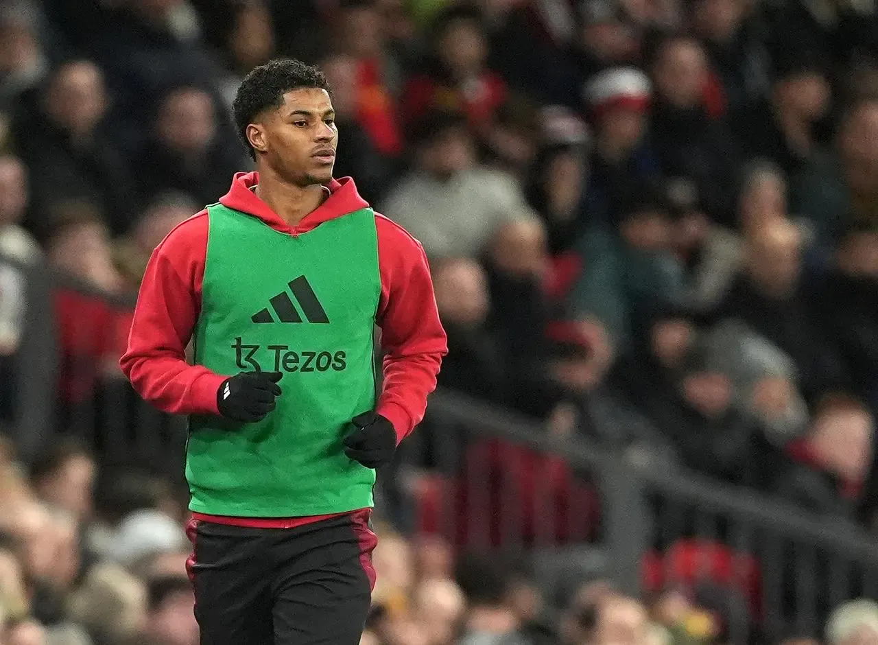 Marcus Rashford warms up on the touchline