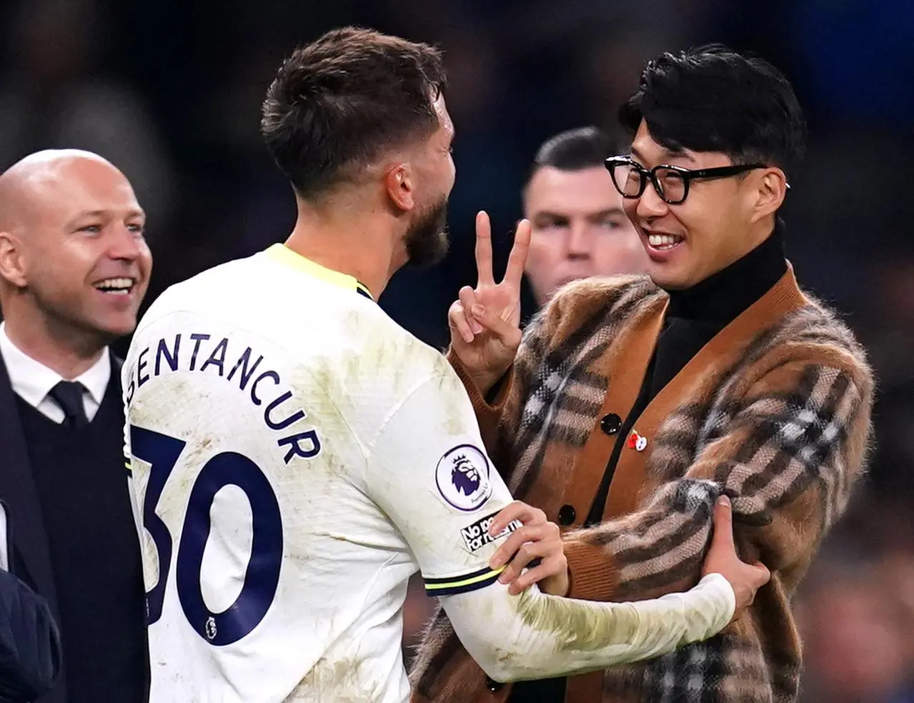 Son Heung-min and Tottenham team-mate Rodrigo Bentancur lock arms and smile  