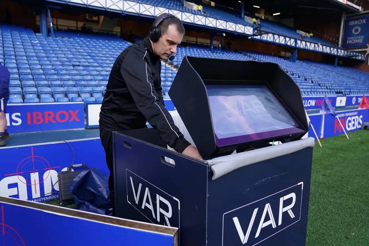 Referee Alan Muir sets up a pitchside VAR monitor