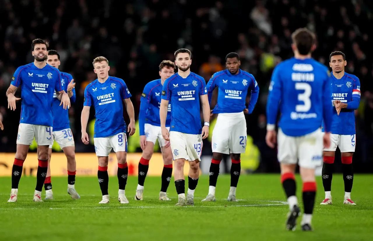 Rangers’ Ridvan Yilmaz walks back to his team-mates after missing in the penalty shoot-out against Celtic