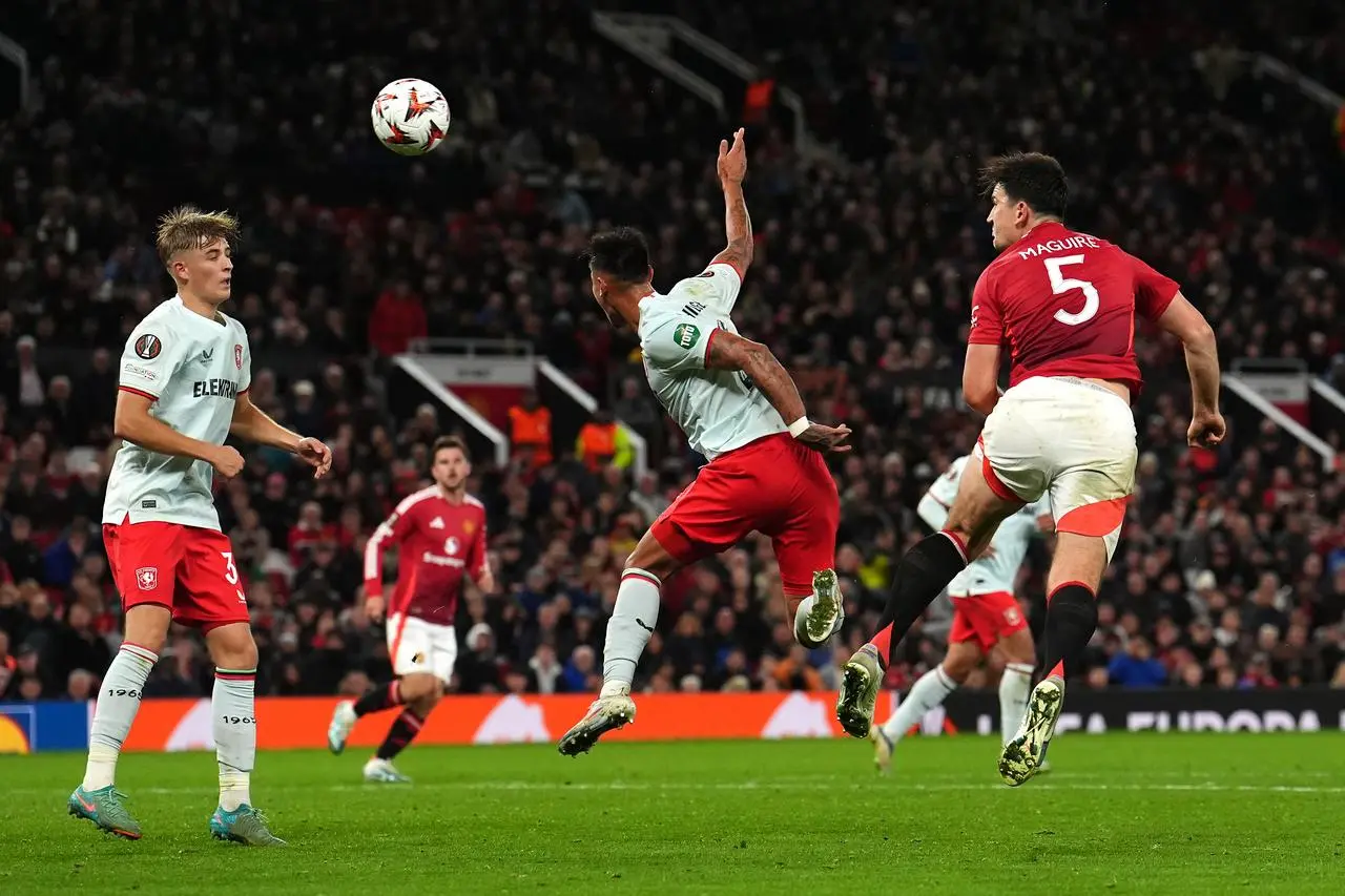 Harry Maguire, right, leaps to head the ball