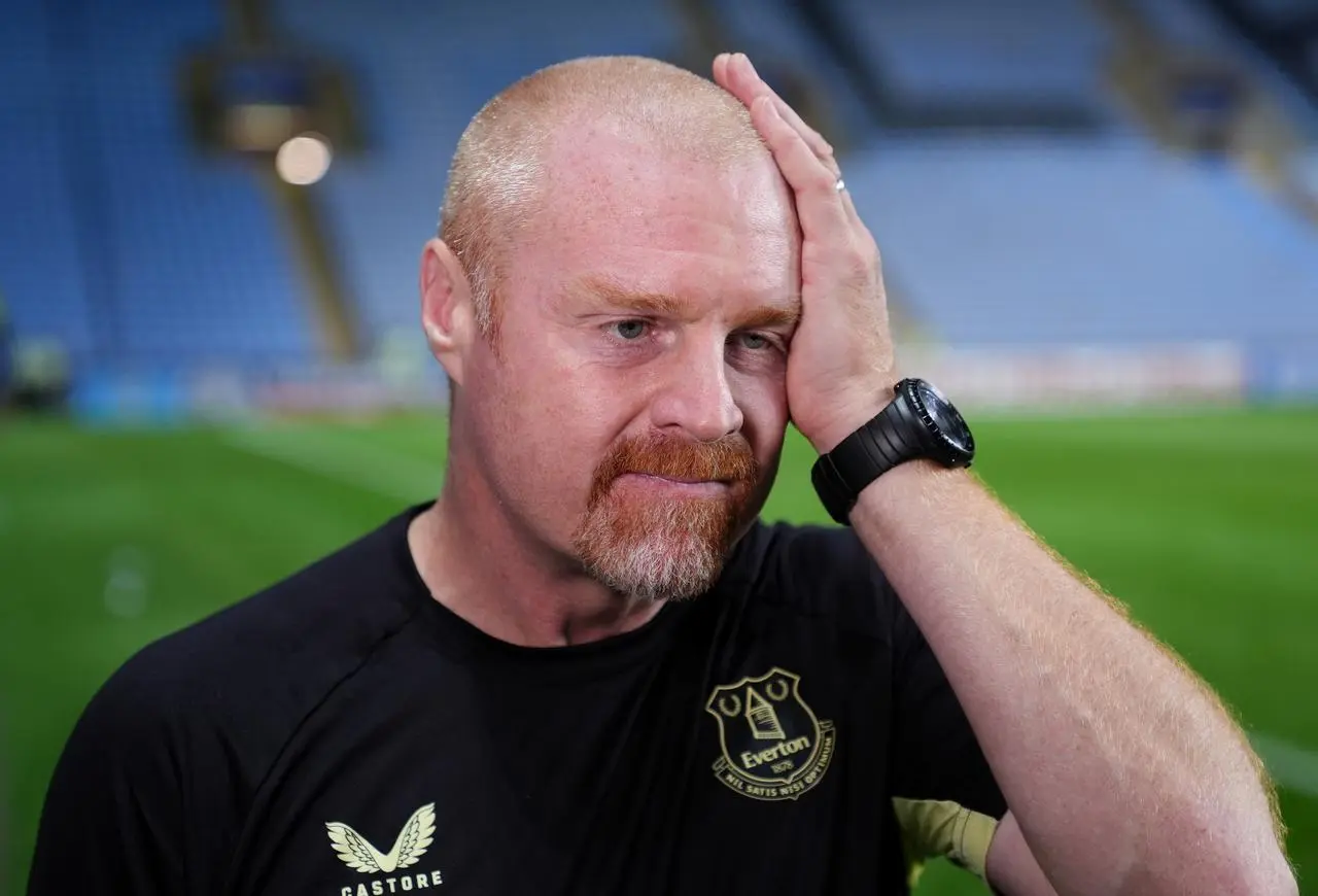 Everton manager Sean Dyche touches the side of his head with his left hand