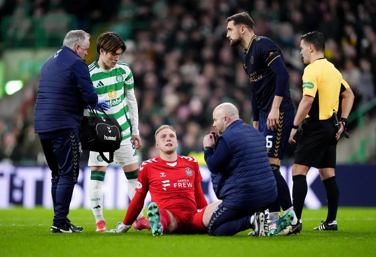 Kilmarnock goalkeeper Robby McCrorie receives treatment against Celtic