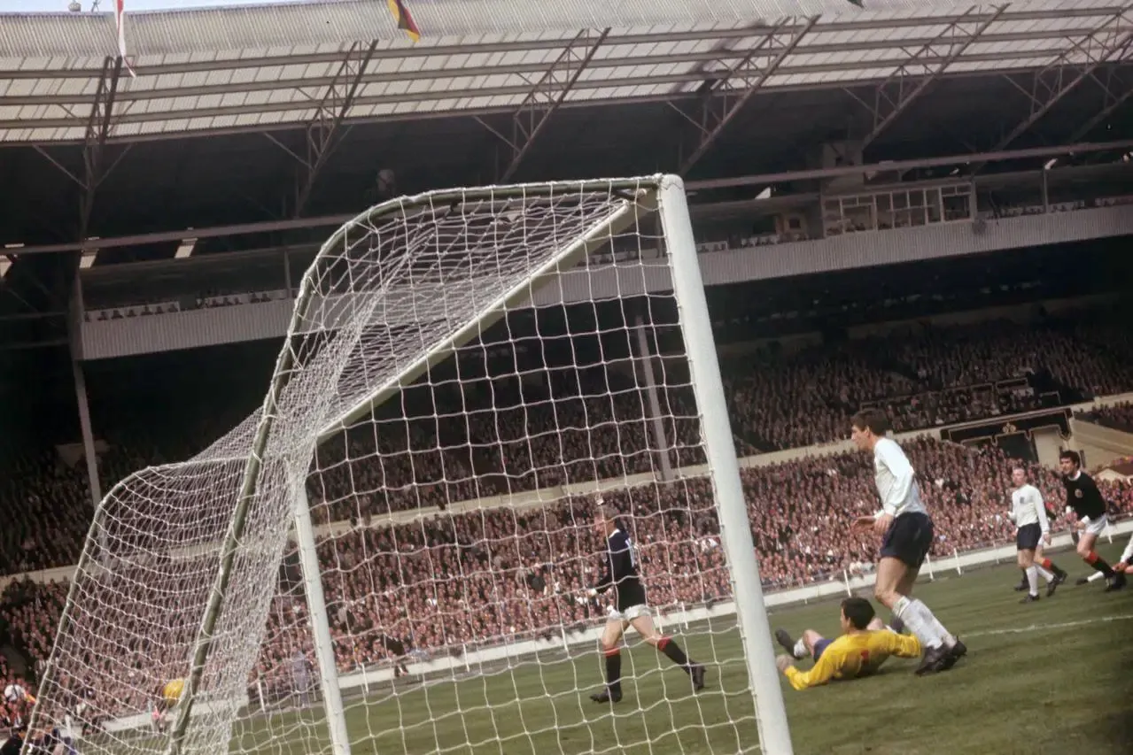 Denis Law celebrates scoring for Scotland against England