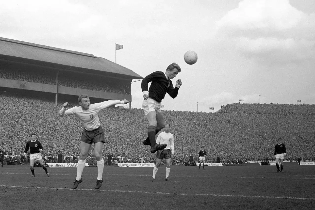 Scotland’s Denis Law wins the ball ahead of England’s Bobby Moore