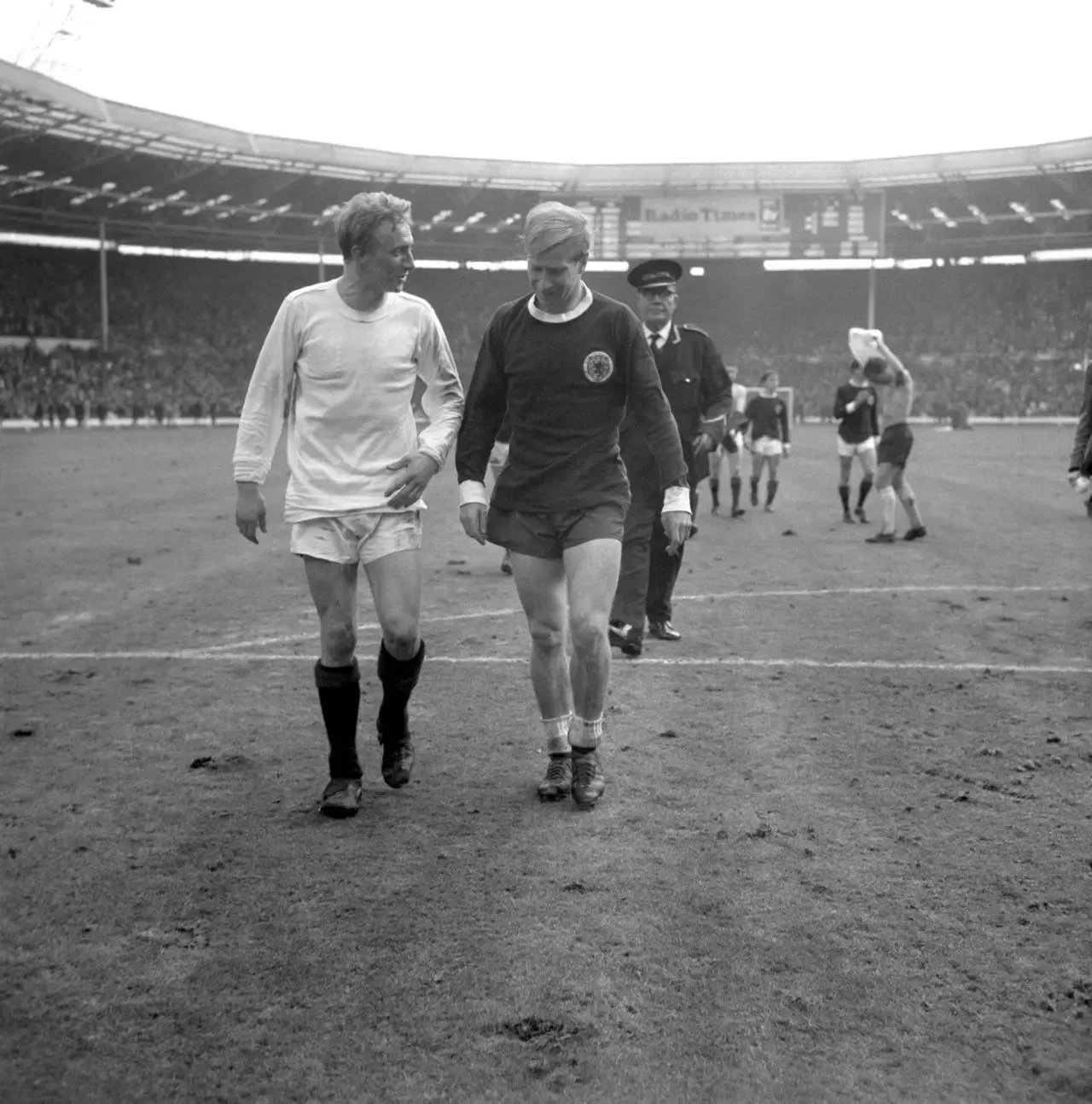 Scotland inside-left Denis Law (left) and England outside-left Bobby Charlton (right) leave the pitch