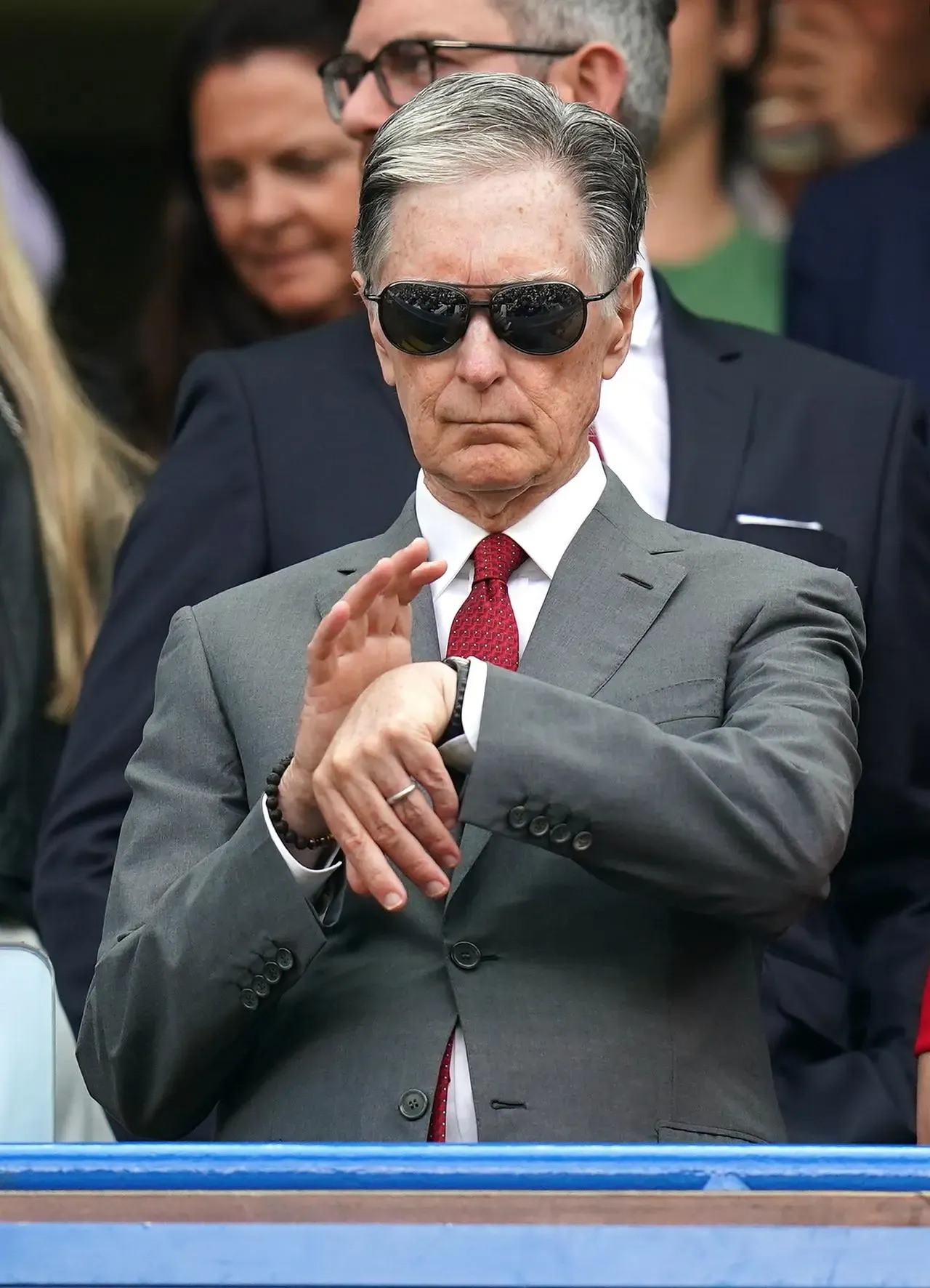 Liverpool principal owner John Henry looks at his watch 