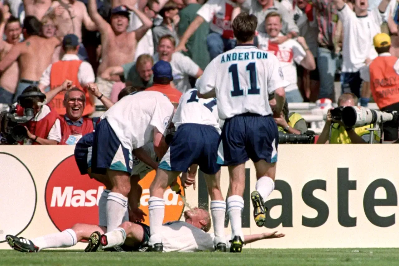 Paul Gascoigne is swamped by England team-mates after scoring against Scotland at Euro 96