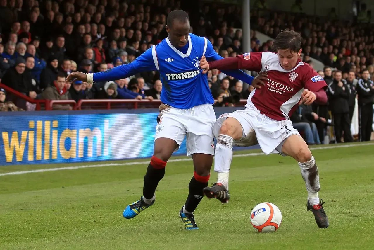 Rangers’ Sone Aluko, left, and Arbroath’s Josh Falkingham in Scottish Cup action