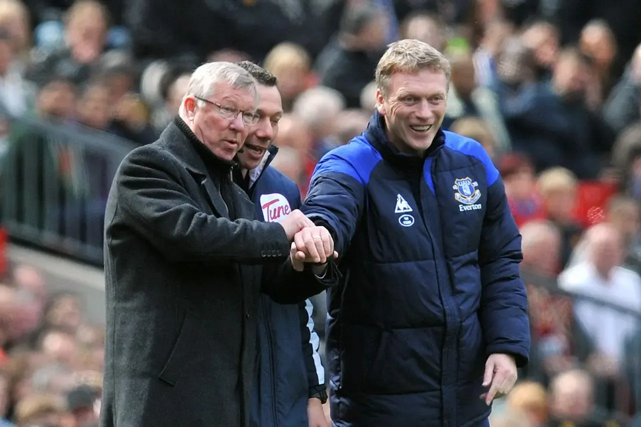 Manchester United manager Sir Alex Ferguson and Everton manager David Moyes stand next to each other on the touchline