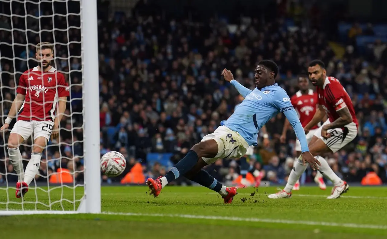 Divin Mubama slides home Man City's second goal