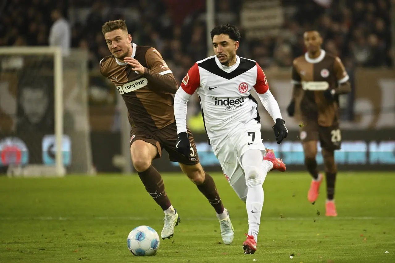 Eintracht Frankfurt’s Omar Marmoush challenges an opponent for the ball 