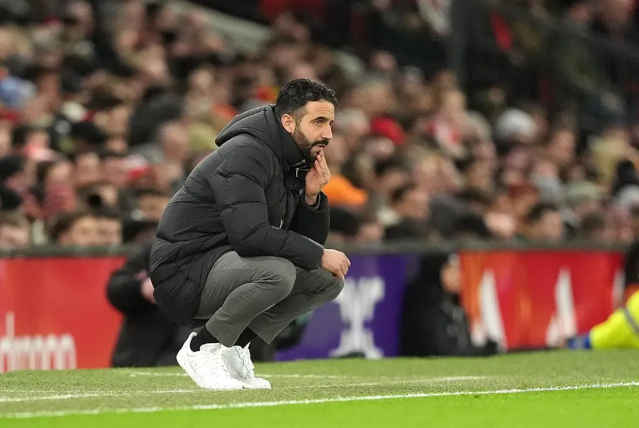 Ruben Amorim crouching on the touchline