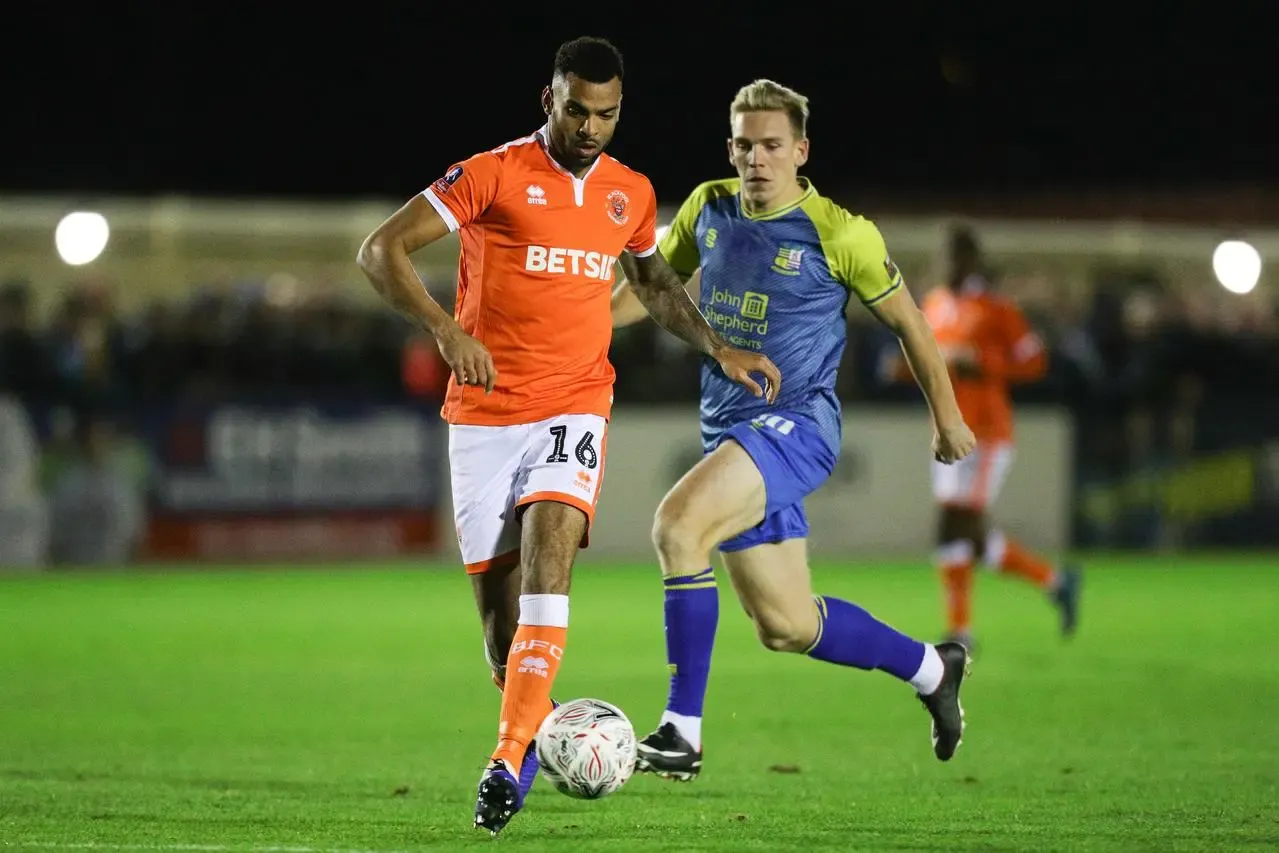 Curtis Tilt (left), then of Blackpool, battle for the ball with Solihull Moors' Jermaine Hylton