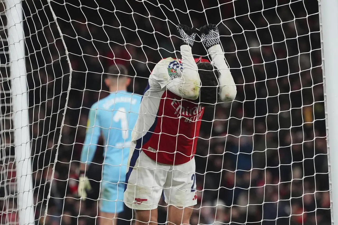 Kai Havertz grips onto the net and puts his head down after missing a chance