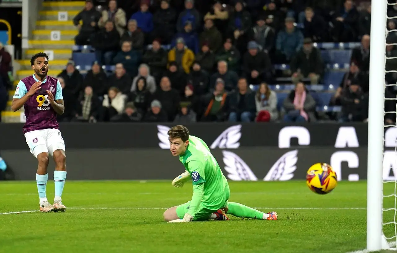 Burnley’s Lyle Foster, left, shoots wide of Oxford's goal