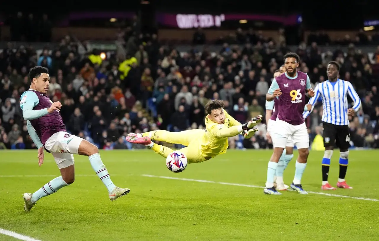 Burnley goalkeeper James Trafford, centre, saves a shot during the win over Sheffield Wednesday