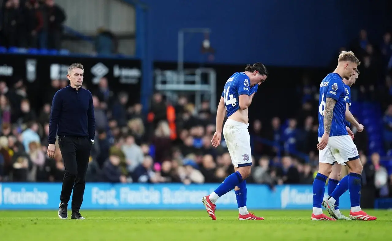 Ipswich manager Kieran McKenna, left, and players Jacob Greaves, Luke Woolfenden and Jack Taylor leave the pitch after defeat to Tottenham