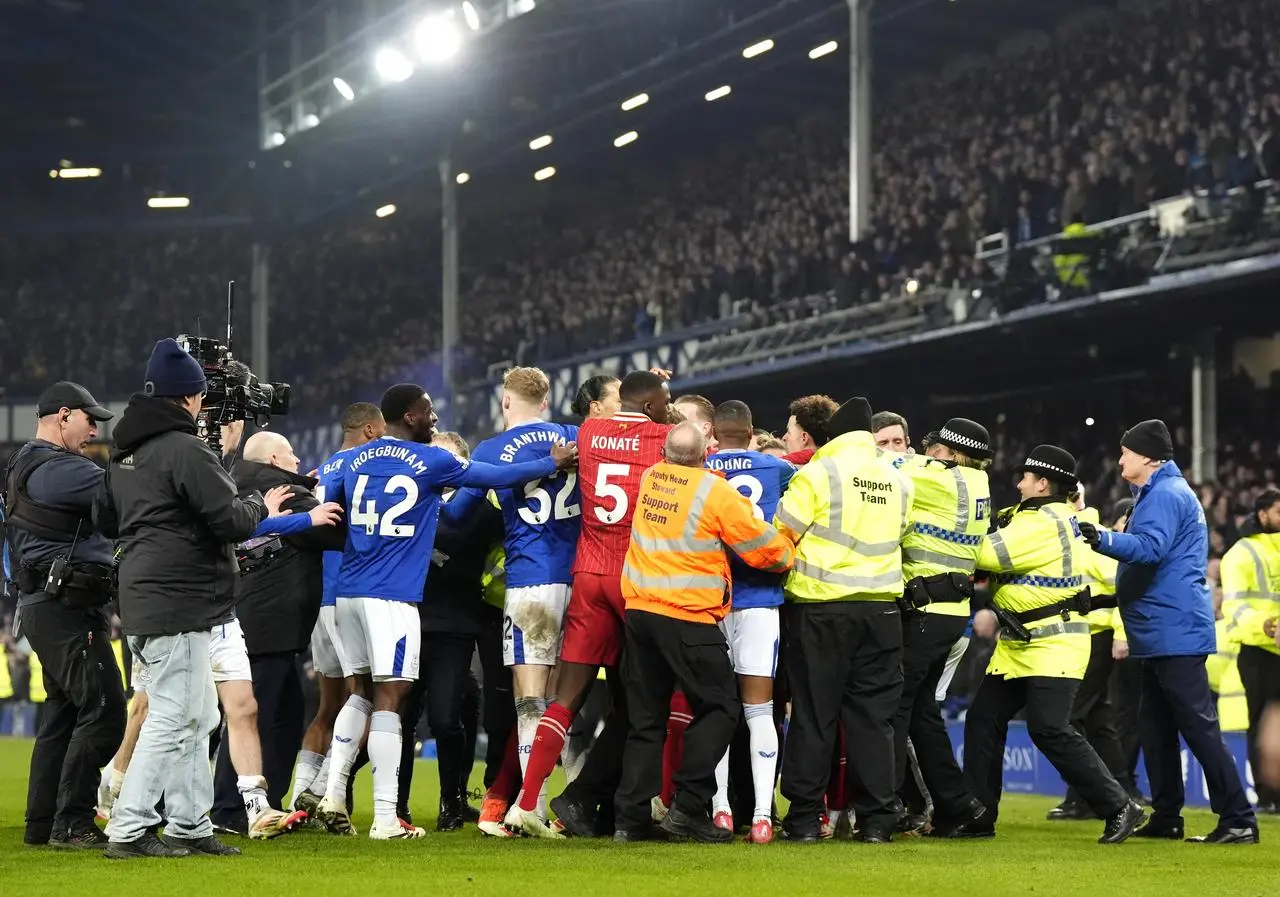 Liverpool’s Curtis Jones (centre) and Everton’s Abdoulaye Doucoure are separated by team-mates and members of the ground staff following a clash before both being shown red cards