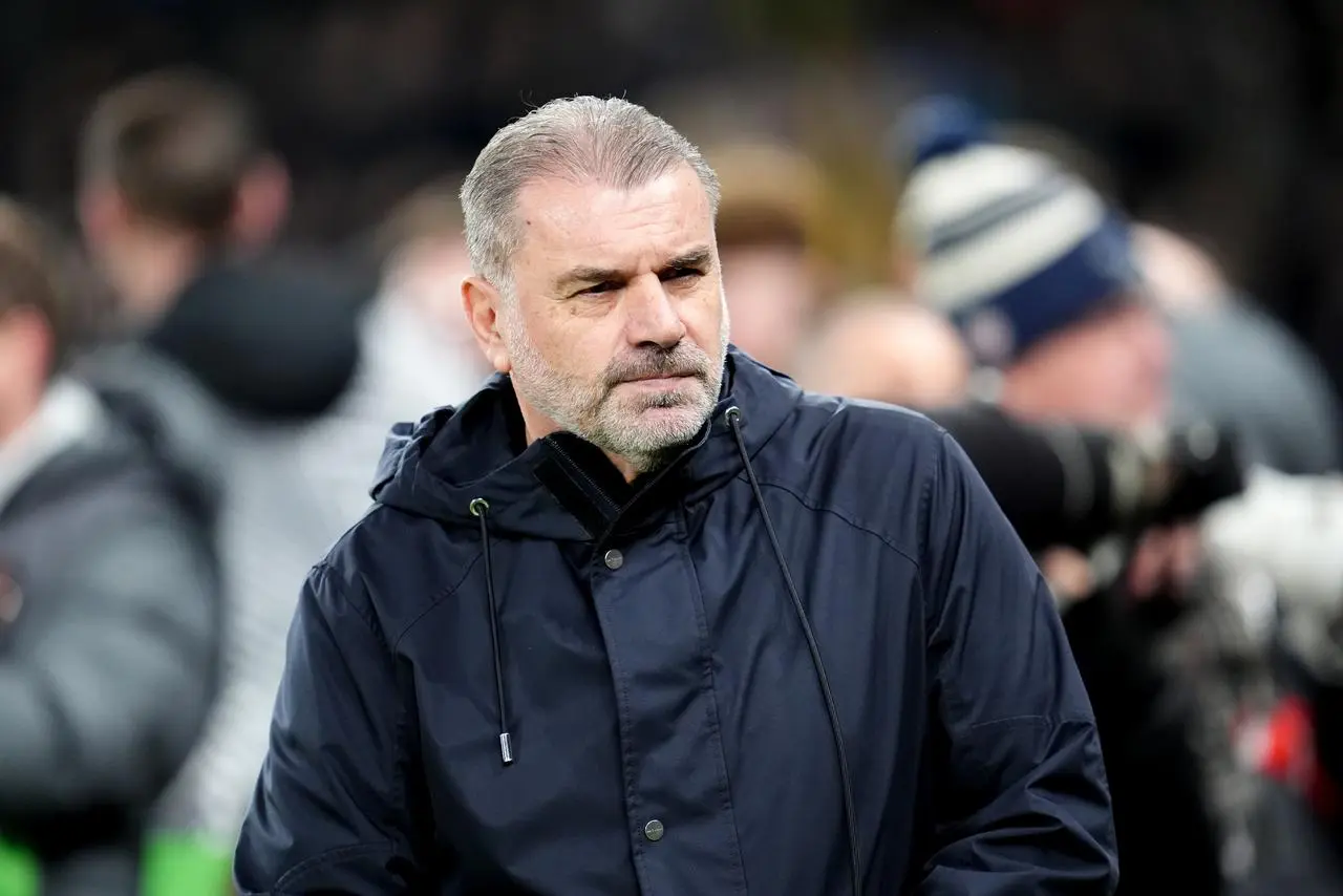 Tottenham Hotspur manager Ange Postecoglou wearing a coat