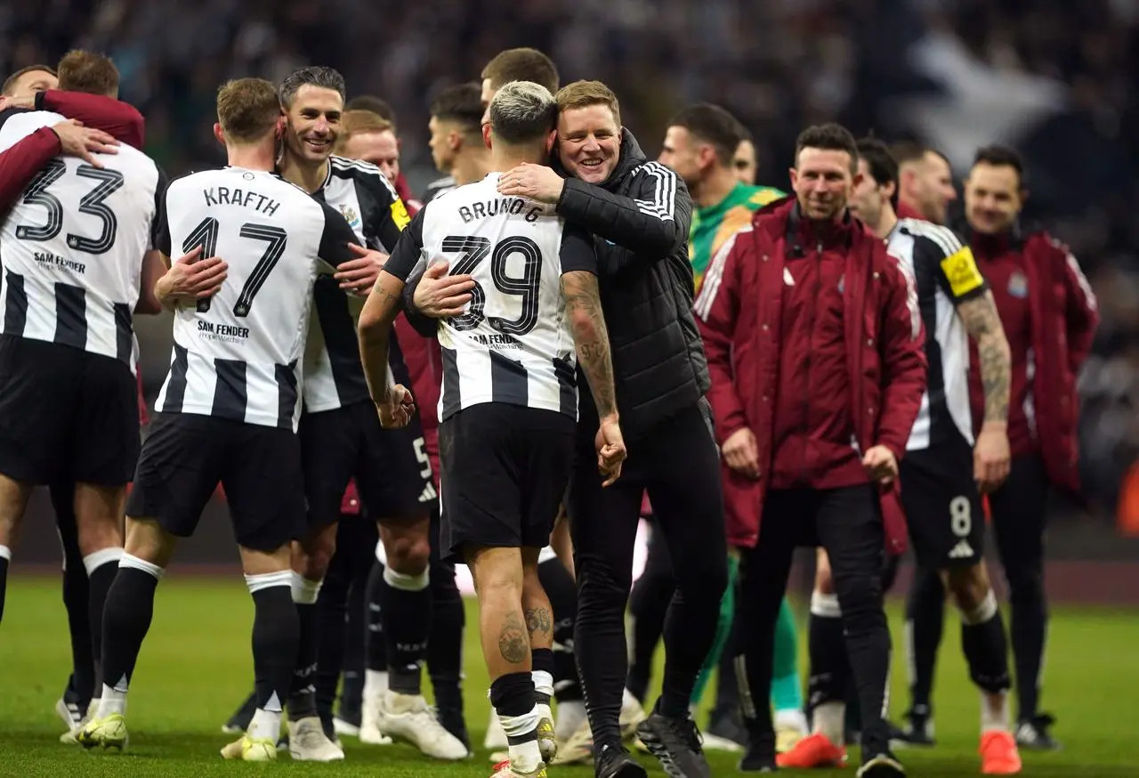 Newcastle head coach Eddie Howe embraces captain Bruno Guimaraes after the Carabao Cup semi-final, second leg victory over Arsenal