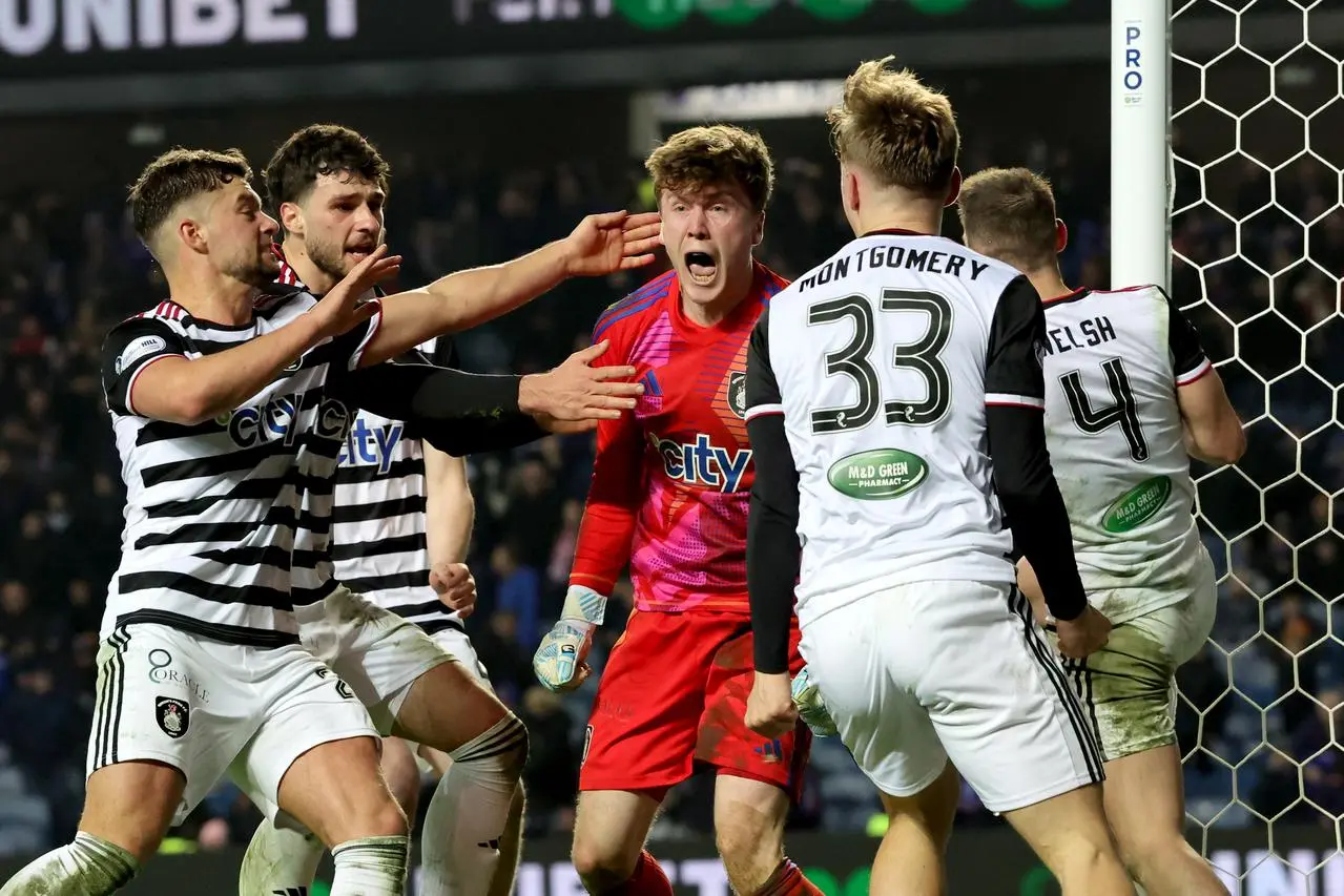 Calum Ferrie, centre, celebrates after saving James Tavernier's penalty