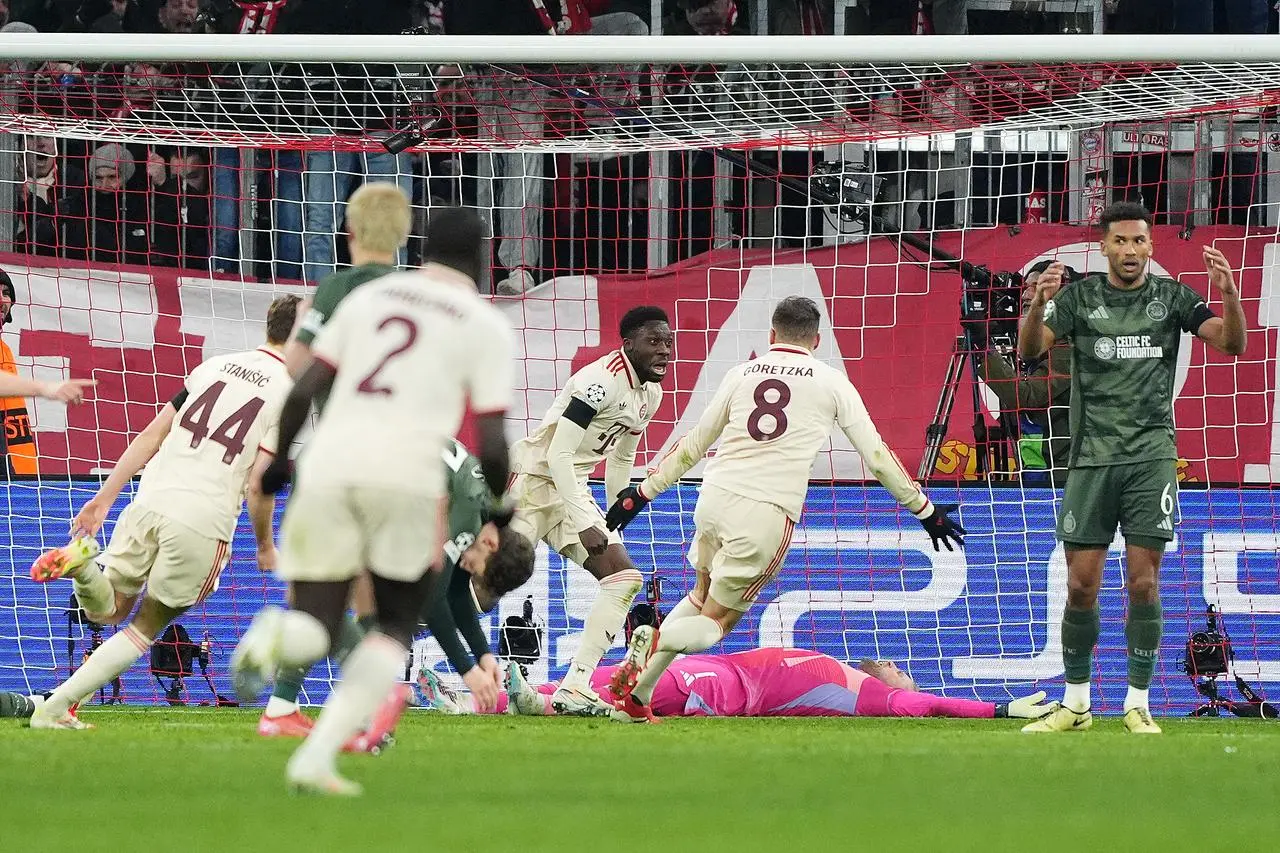 Alphonso Davies (centre) celebrates after scoring Bayern's late equaliser