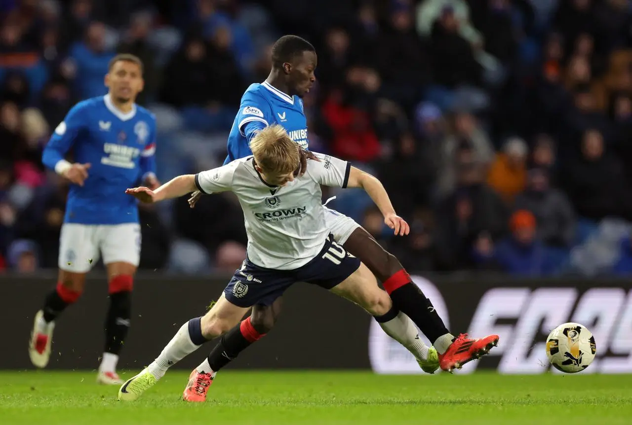 Lyall Cameron battles for the ball against Rangers